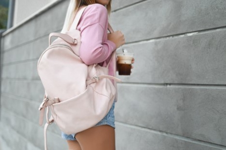 girl with backpack and coffee