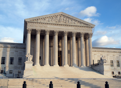 Grand entrance of the United States Supreme Court in warm afternoon light.