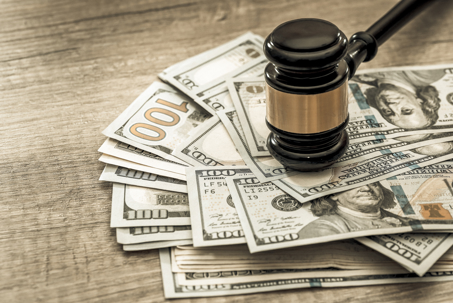wooden gavel with usa dollar on desk